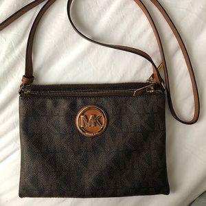 Michael Kors logo over the shoulder bag